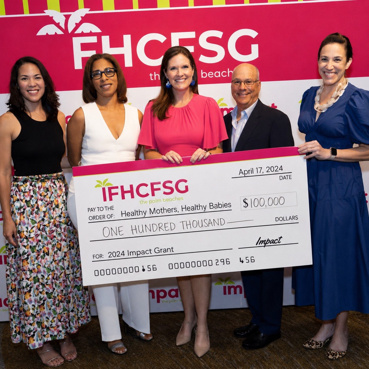 Healthy Mothers, Healthy Babies receiving a grant check