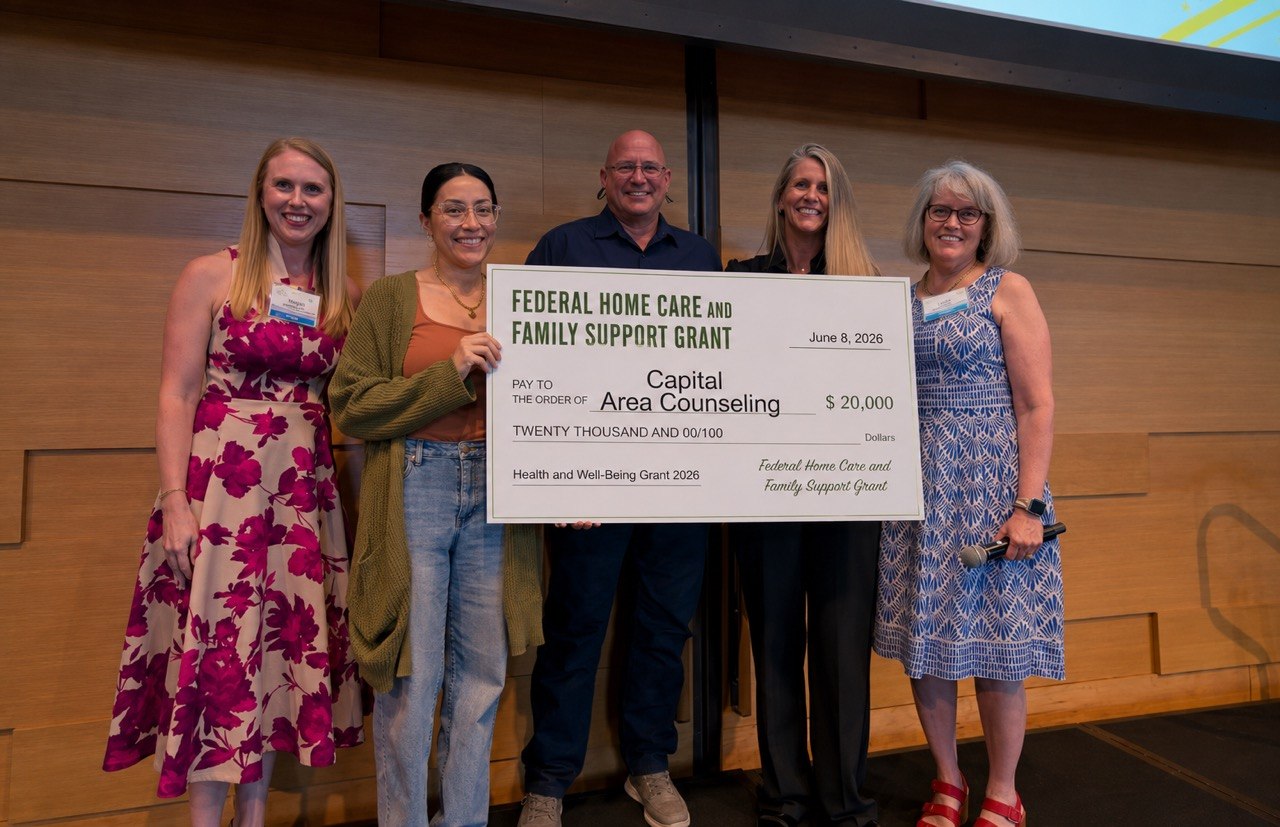 Capital Area Counseling receiving a grant check