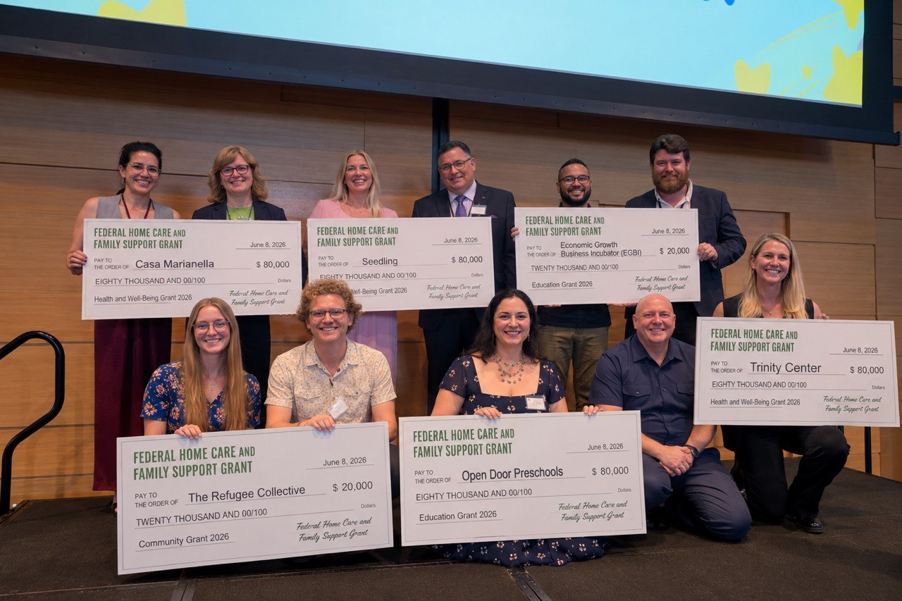 FHCFSG 2026 grant recipients holding ceremonial checks on stage